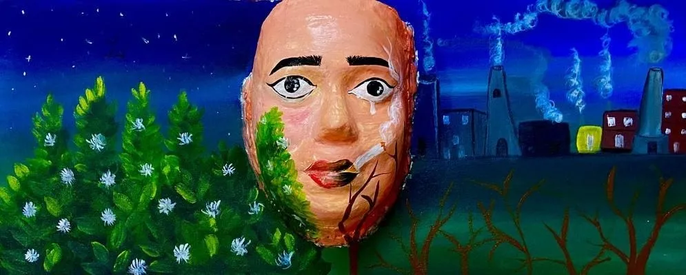 The Safe Air mask: one half painted with factory chimneys and smoke, the other with trees and open sky.
